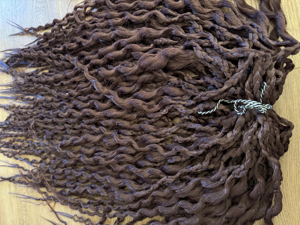 Dark brown wavy dreads and braids