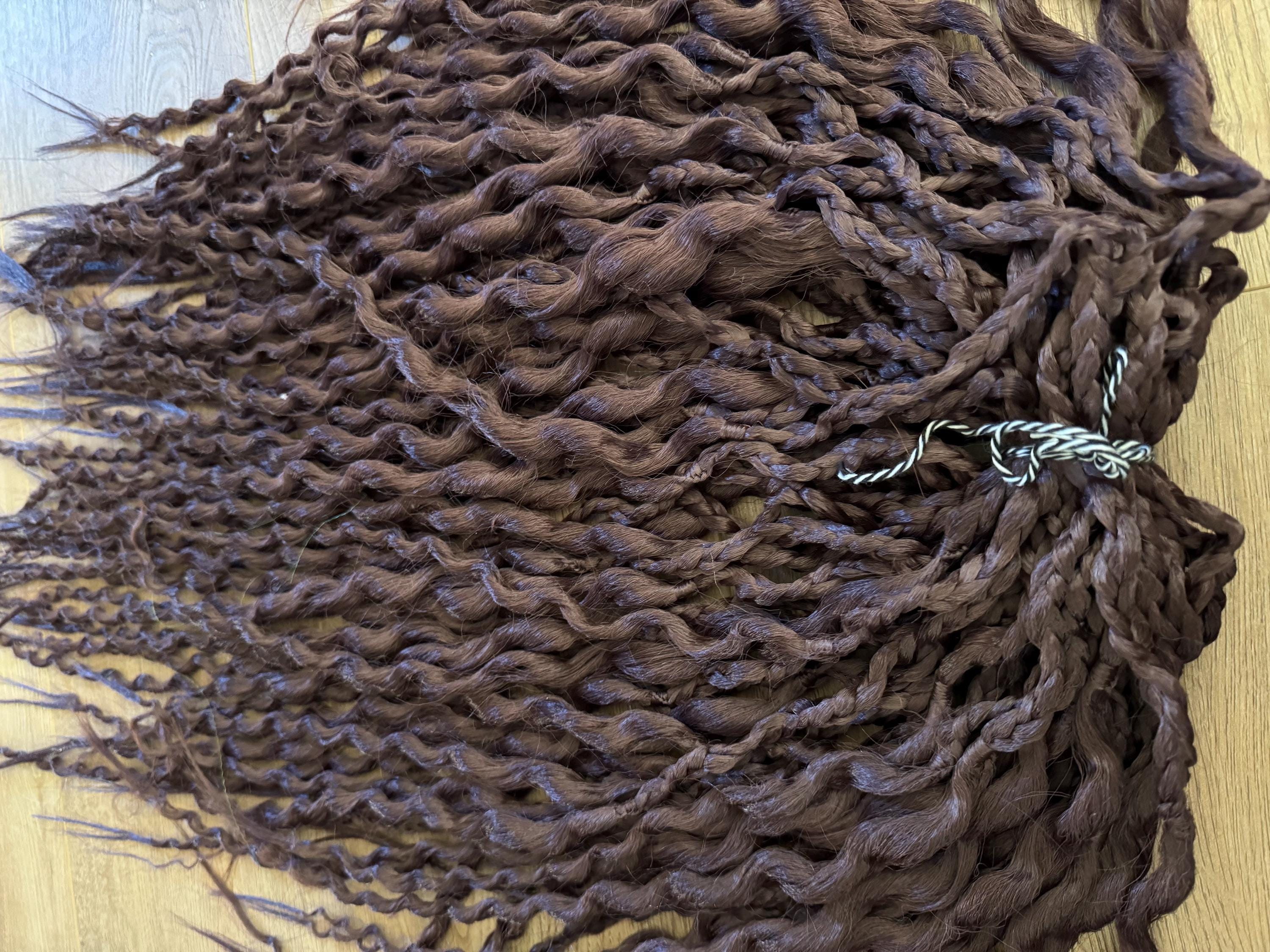 Dark brown wavy dreads and braids