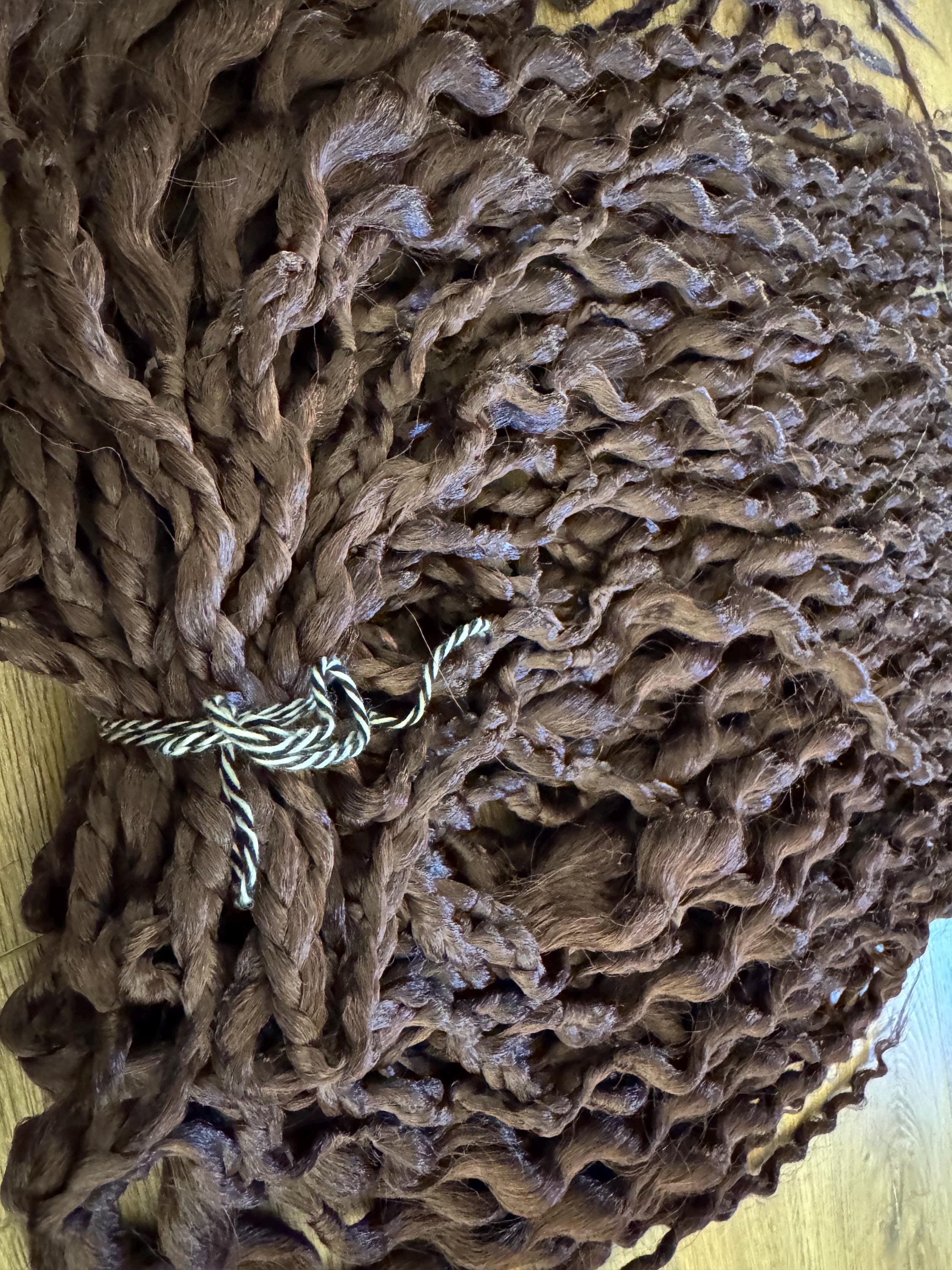 Dark brown wavy dreads and braids